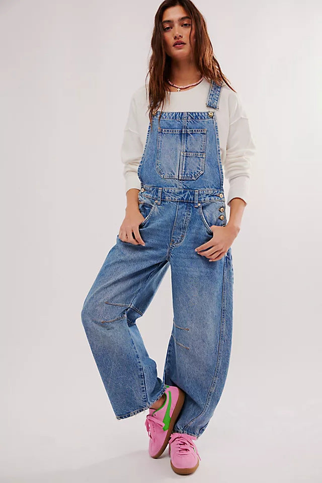 Oversized women's denim overalls with front and back pockets, designed for ultimate comfort and casual style.