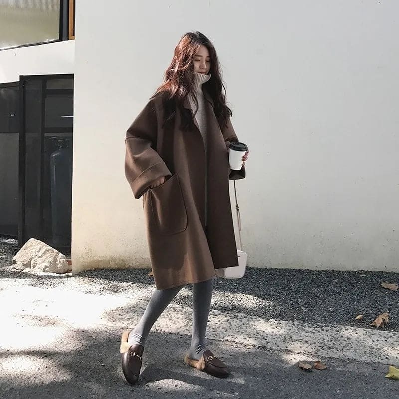 Classic long women's trench coat, oversized and sophisticated for business casual attire.