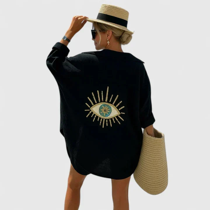 Women's Evil Eye oversized button-down shirt. Versatile beach cover-up & casual top for summer style & resort wear.