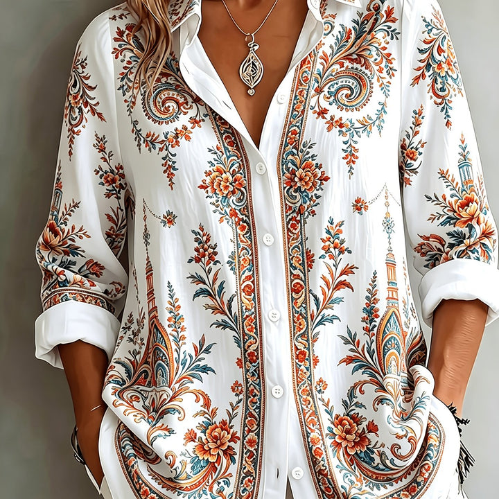 Woman enjoying a relaxed day in a floral paisley oversized long sleeve blouse. Perfect casual summer wear.