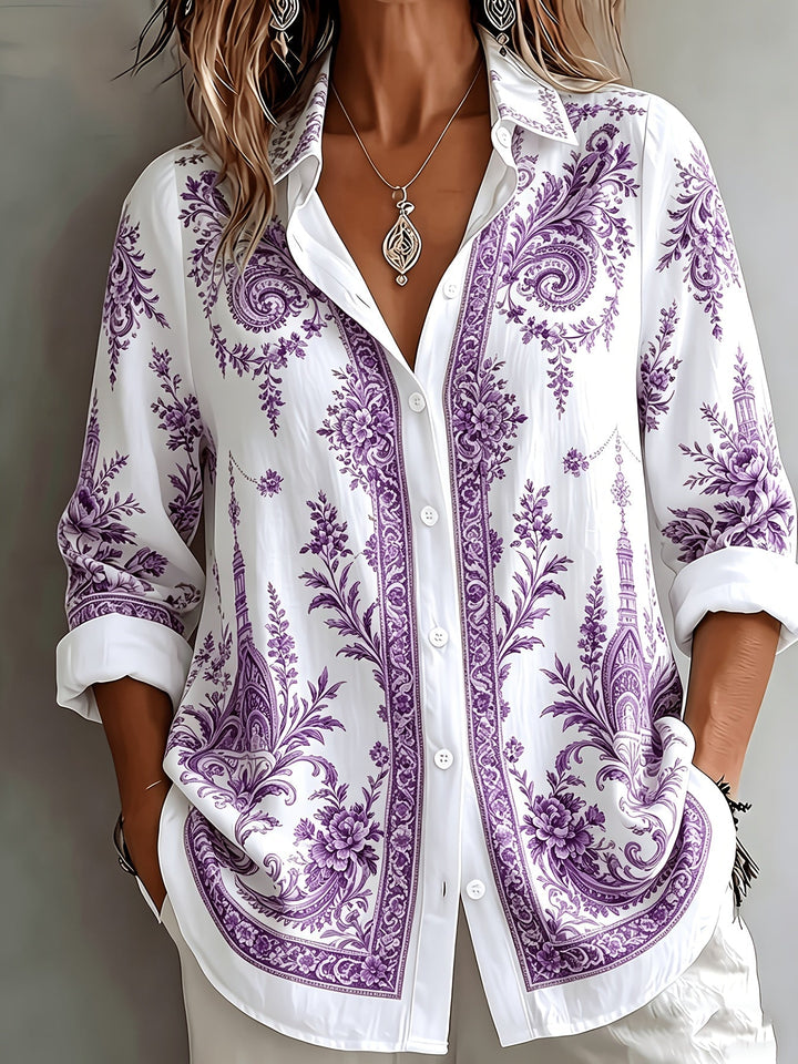 Woman modelling a flowing floral paisley oversized long sleeve blouse. Perfect for a chic summer look.