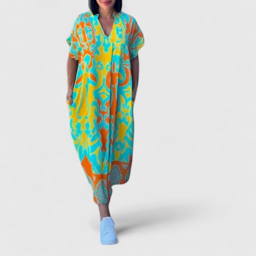 Casual women's oversized maxi dress, short sleeve, with a vibrant abstract baroque print. Comfortable summer and resort wear.