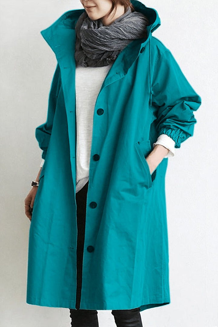 Elegant women's oversized rain parka trench, a chic water resistant coat for stylish transitional wear.