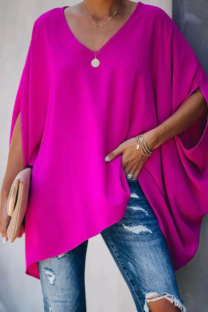 Women's oversized v-neck tunic top with stylish batwing sleeves for a comfortable, relaxed fit. Perfect for casual wear.