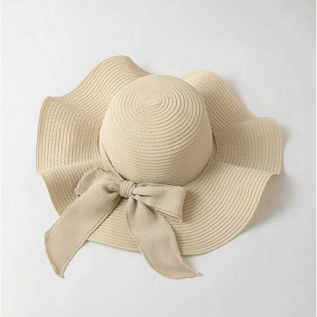 Chic women's wide brim sun hat, an oversized beach accessory for stylish summer sun protection.