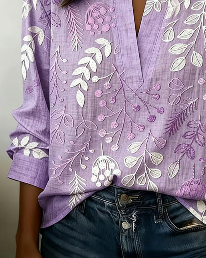 Elegant women's V-neck blouse with delicate pastel floral print, ideal for casual or workwear.