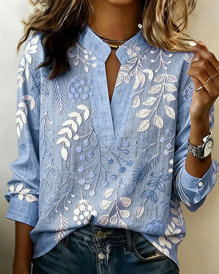 Feminine women's blouse featuring a vibrant pastel floral print and flattering V-neck design.