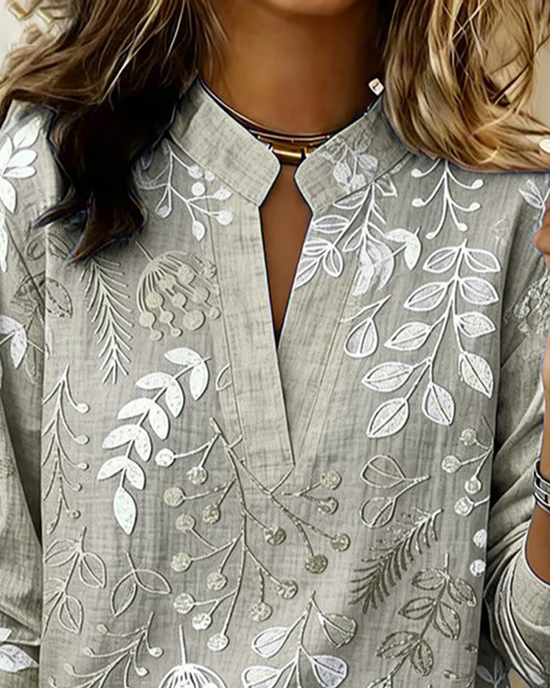 Stylish V-neck women's blouse with soft pastel floral print, perfect for a feminine spring look.