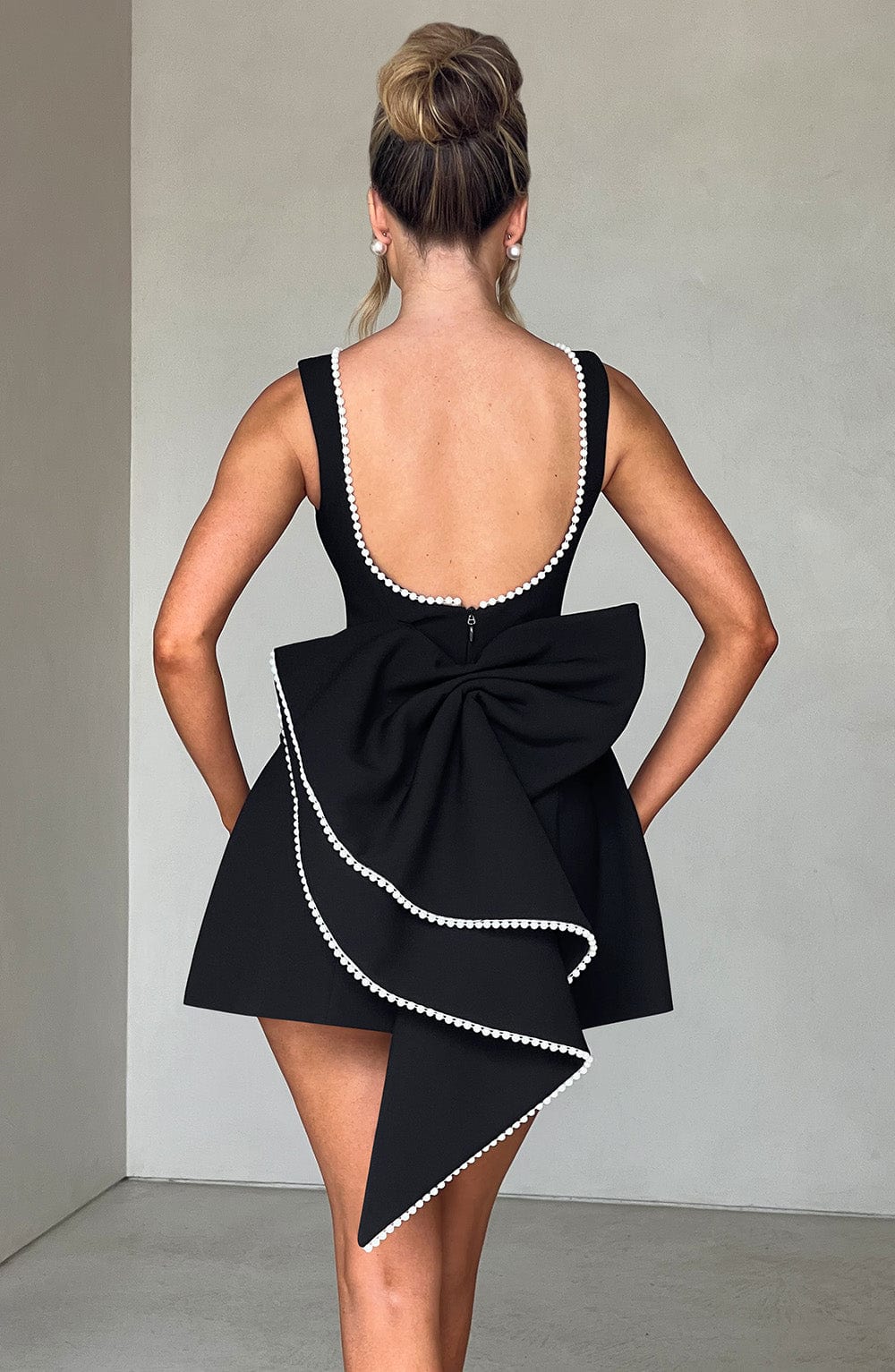 Chic women's evening or party mini dress, A-line style with elegant pearl trim, suitable for special occasions.