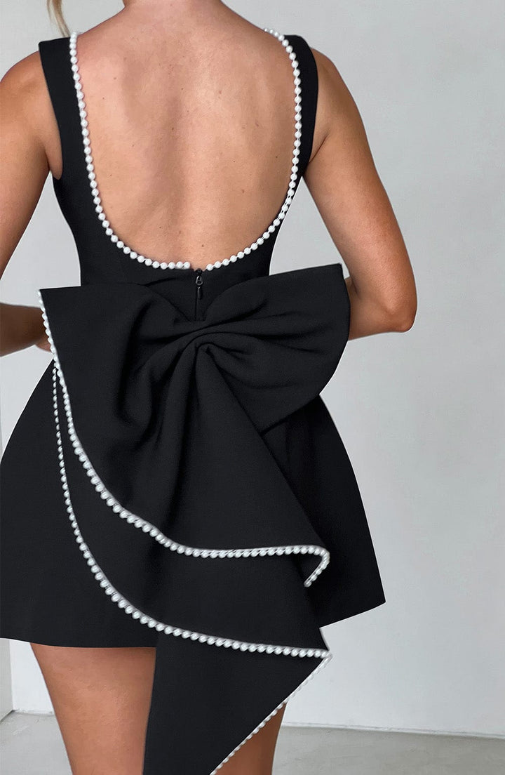 Women's elegant A-line mini homecoming dress, featuring pearl trim, a fitted bodice, and a bow accent.