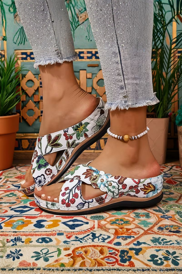 Versatile women's slip-on wedge sandals featuring a stylish perforated design. Perfect casual summer footwear.