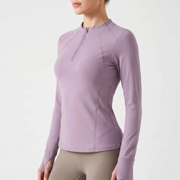 Women's long-sleeve quarter-zip performance top for running, yoga, and gym workouts. Essential fitness apparel.