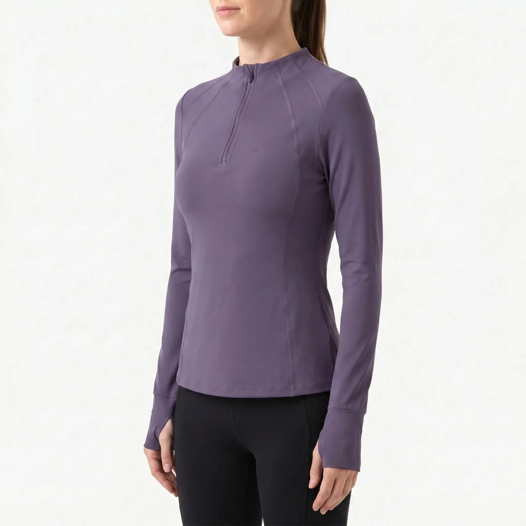 Moisture-wicking women's athletic quarter-zip long-sleeve top. High-performance activewear for training.
