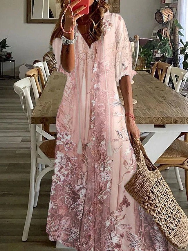 Flowy women's floral print maxi dress with V-neck and half sleeves, perfect for comfortable summer fashion.