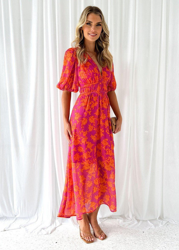 Elegant women's pink orange floral V-neck maxi dress with puff sleeves. Flowing summer style.
