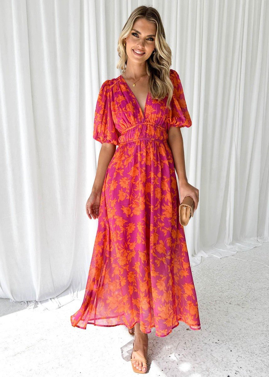 Vibrant pink-orange floral maxi dress for women with a flattering V-neck, chic puff short sleeves, and flowing design.