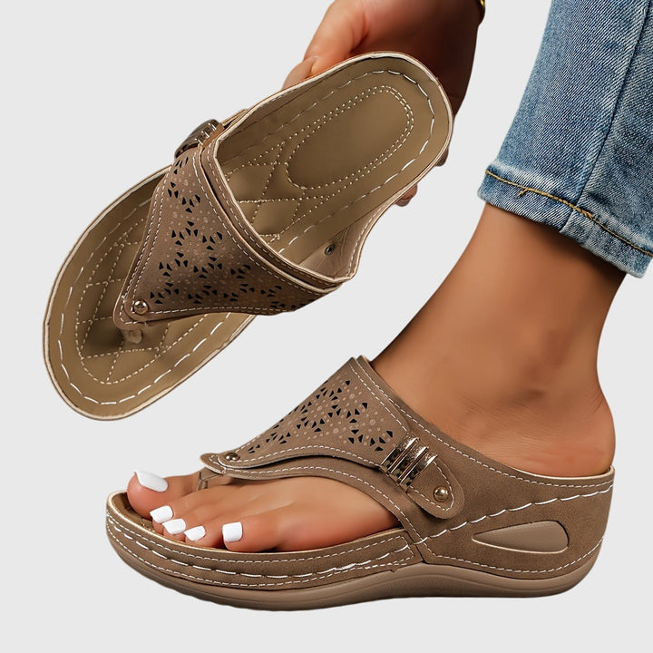 Women's platform ankle strap sandals with elegant perforated design, offering stylish comfort.