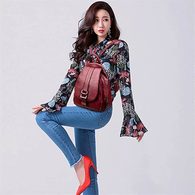Structured water-resistant women's leather backpack, offering timeless elegance.