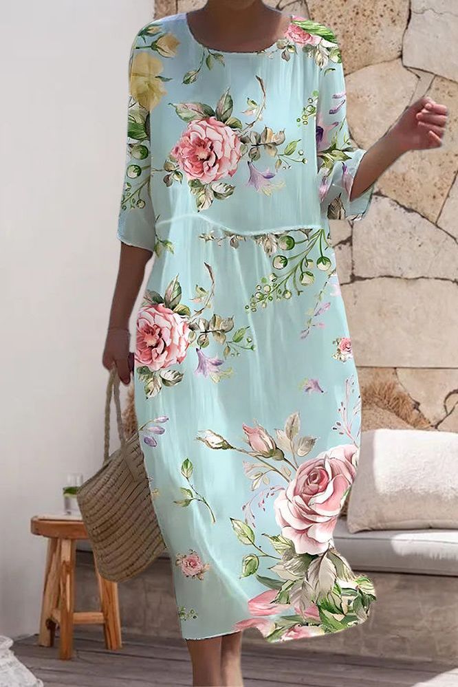 Elegant women's midi dress with a vibrant print. Relaxed fit for everyday comfort and versatile summer style.