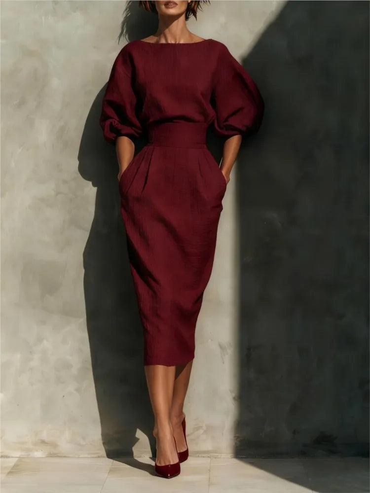 Elegant women's puff sleeve midi dress, chic for fall fashion, features a modest round neck and handy pockets.