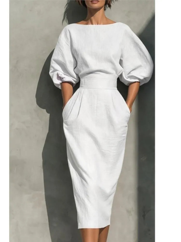 Women's round neck midi dress featuring stylish puff sleeves and convenient side pockets, versatile fall fashion.