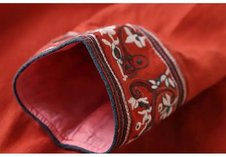 Versatile patterned V-neck top, ladies' relaxed fit, embroidered design.
