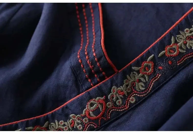 Stylish red patterned blouse, women's relaxed fit, intricate embroidery.