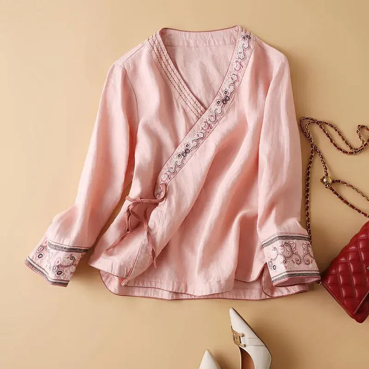 Pink patterned women's blouse, casual chic, V-neck, elegant embroidery details.