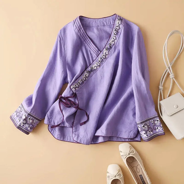 Relaxed fit patterned women's top, V-neck, intricate embroidery, stylish comfort wear.