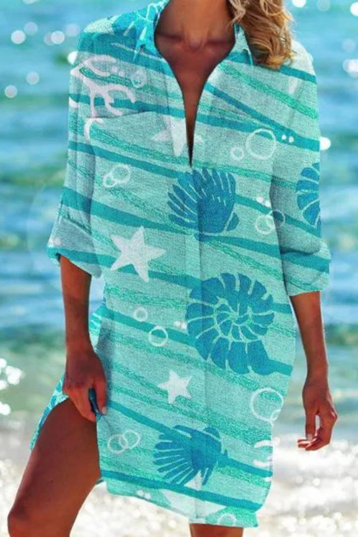Women's tunic style beach cover up with a relaxed fit and vibrant seashell & coral ocean print. Coastal vacation.