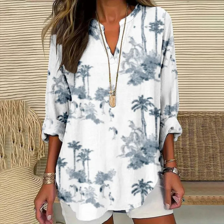 Comfortable women's relaxed fit blouse featuring a modern split neck and folded three-quarter cuffs for versatile wear.