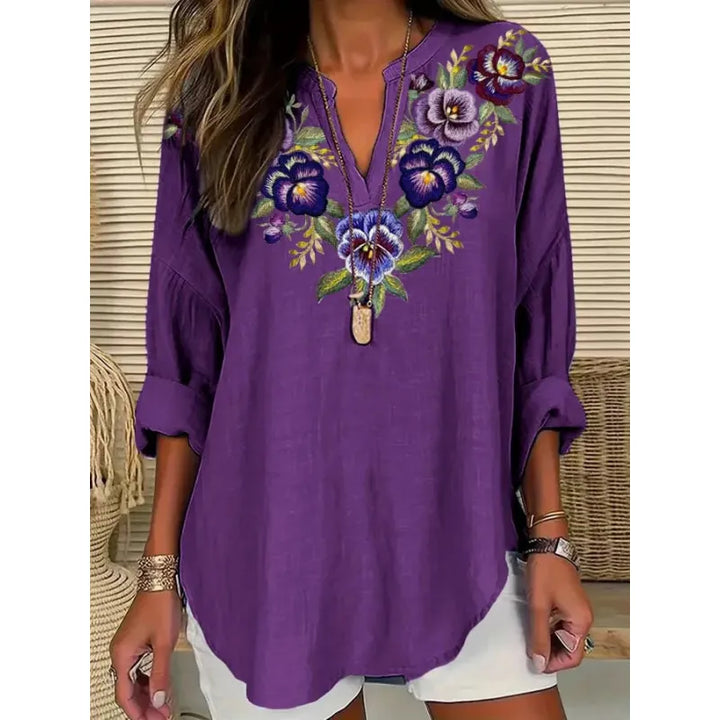 Versatile women's blouse: relaxed fit, split neck, and cuffed three-quarter sleeves for both casual and office styles.
