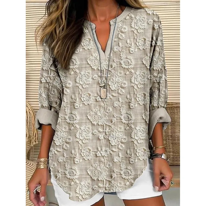 Modern women's relaxed fit top featuring a contemporary split neck and stylish folded three-quarter cuffs.