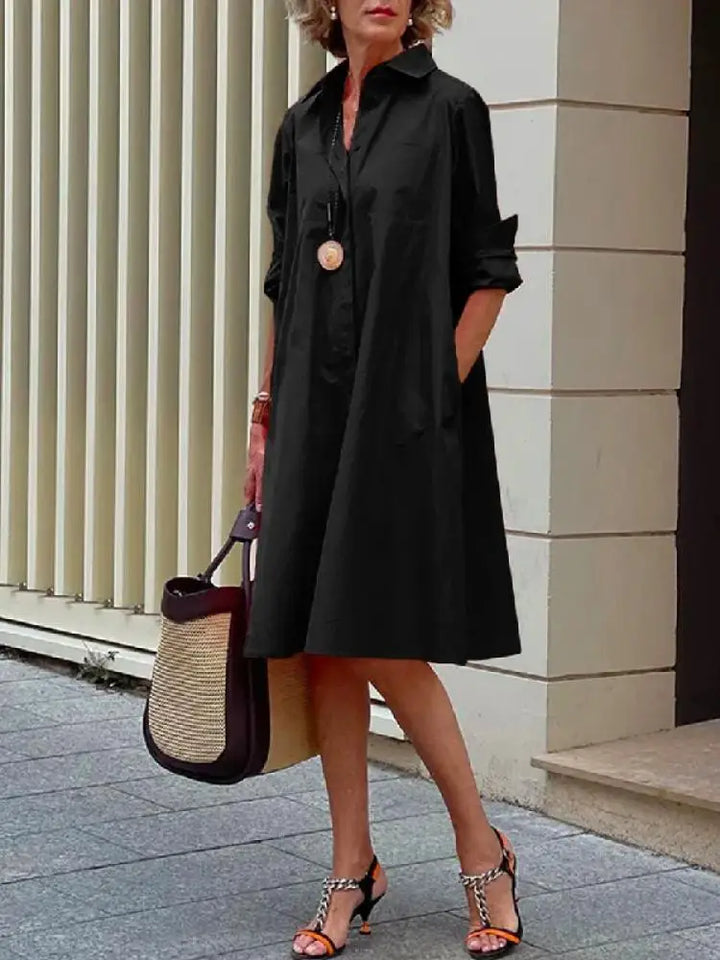Women's relaxed fit button-front A-line midi shirt dress in versatile black for casual or office wear.