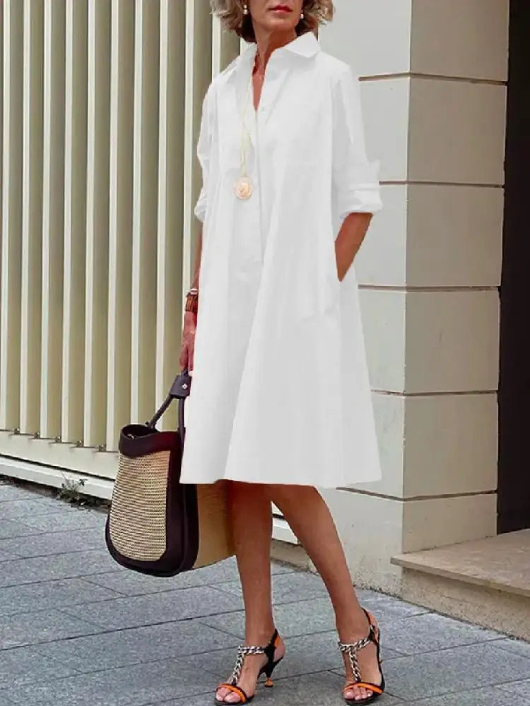 Casual black women's button-front A-line midi dress, a relaxed fit shirt dress ideal for versatile everyday style.