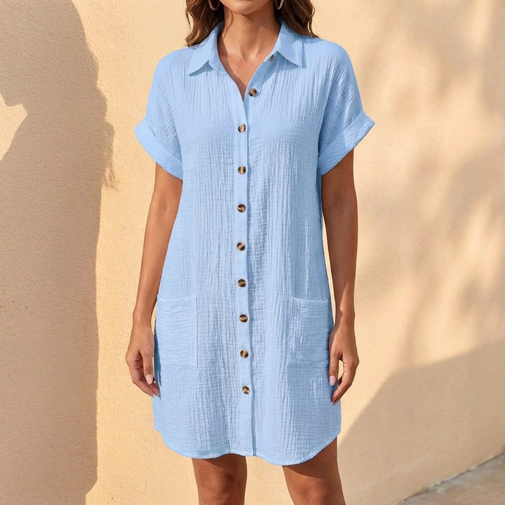 Close-up of a women's relaxed fit midi shirt dress, highlighting button front, collar, and comfortable fabric.