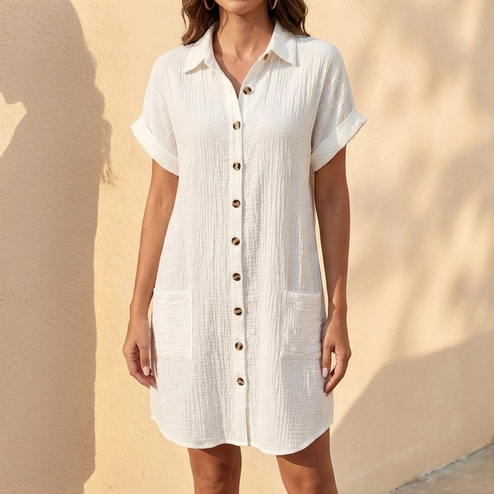 Chic women's midi shirt dress featuring a relaxed fit, button front, and cuffed sleeves for versatile elegance.