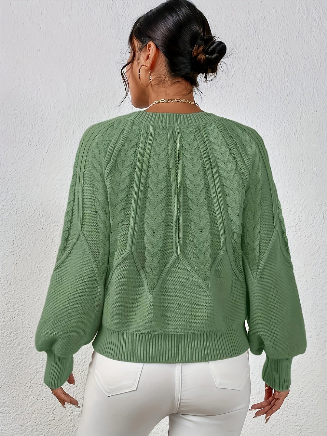 Women's relaxed fit cable knit sweater with stylish lantern sleeves, perfect for cozy fall outfits.