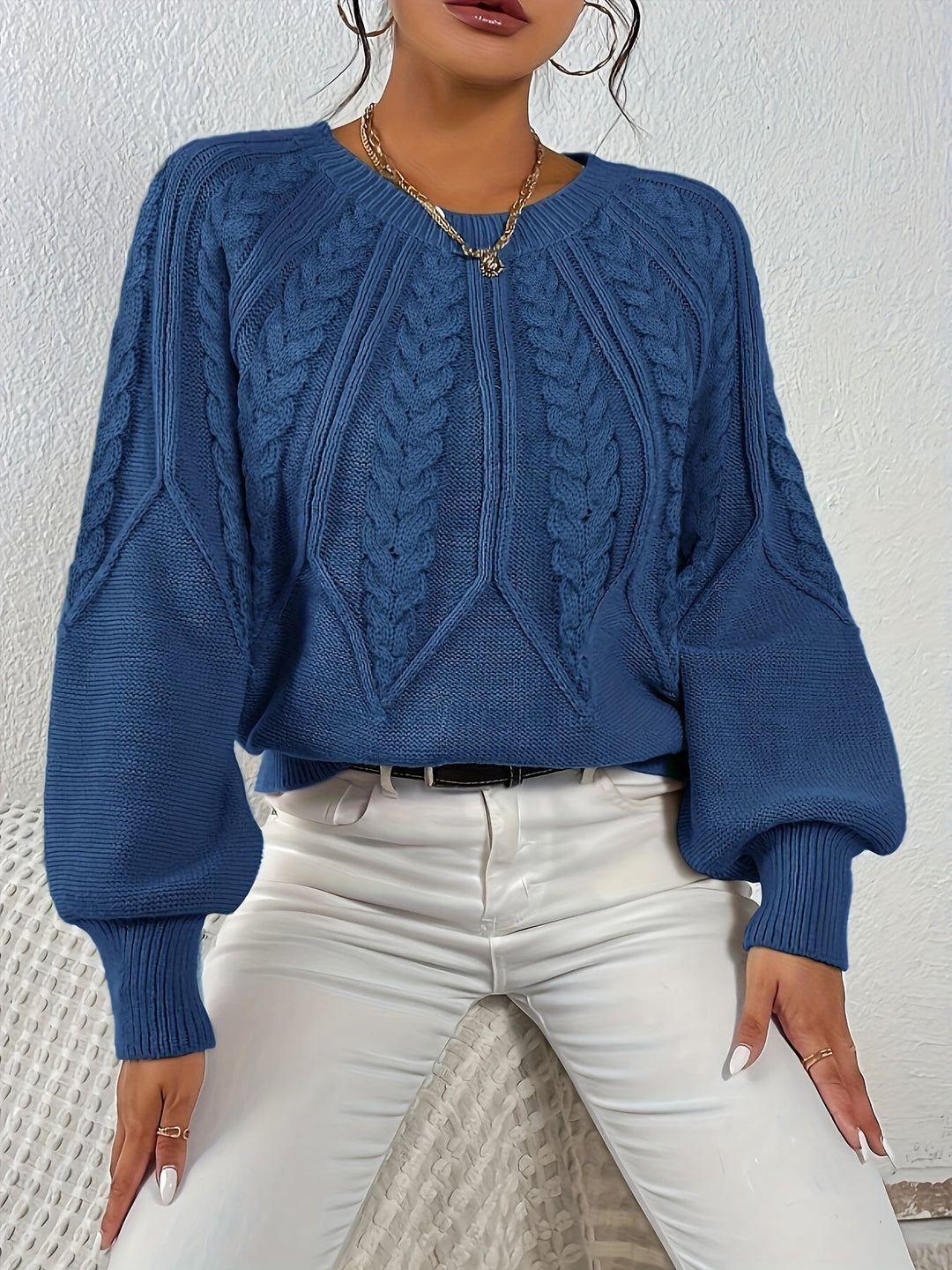 Fashionable women's pullover, cozy cable knit, relaxed fit, and elegant lantern sleeves.