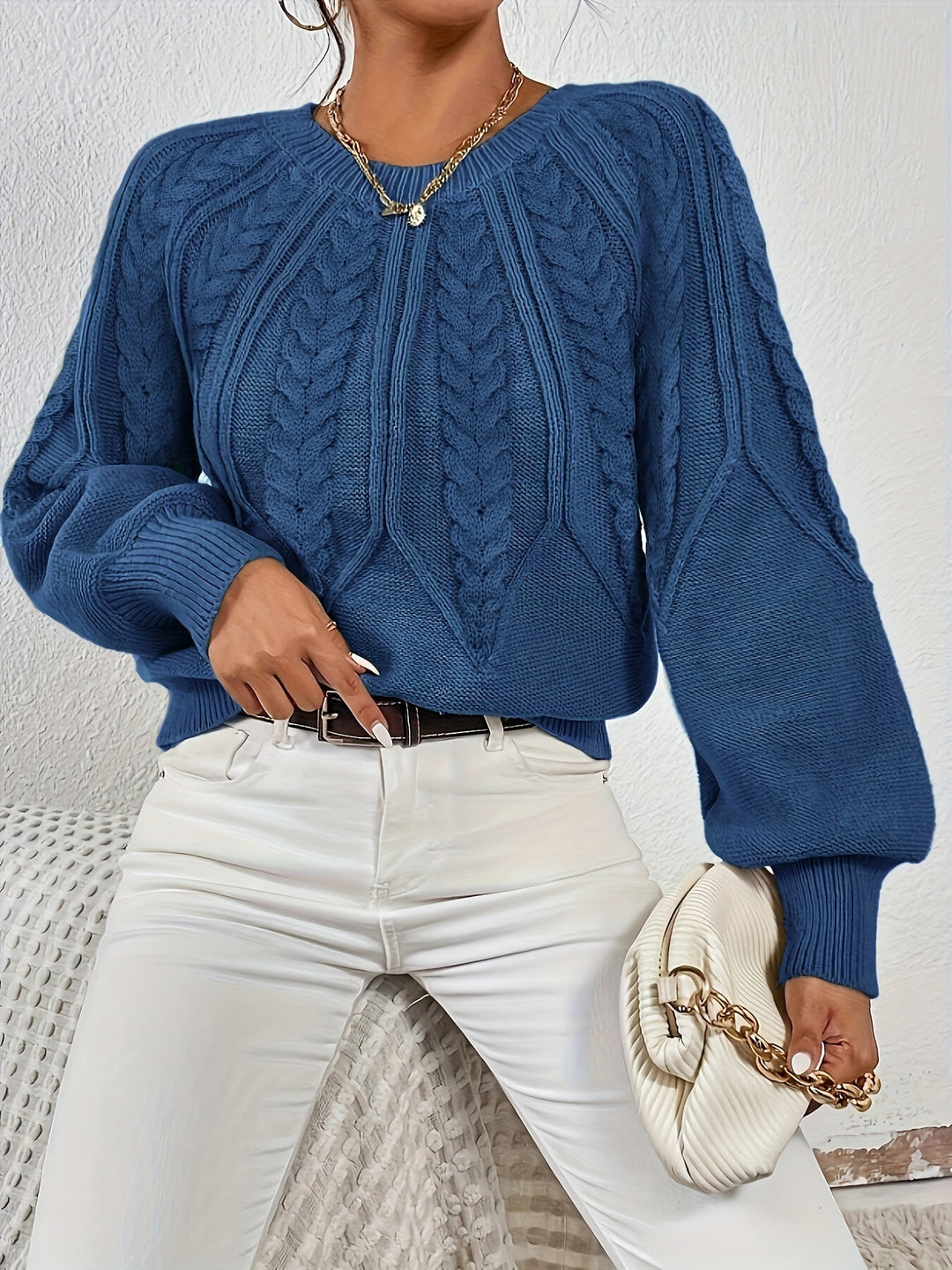 Soft women's cable knit sweater, relaxed fit, perfect for fall, with lantern sleeves.