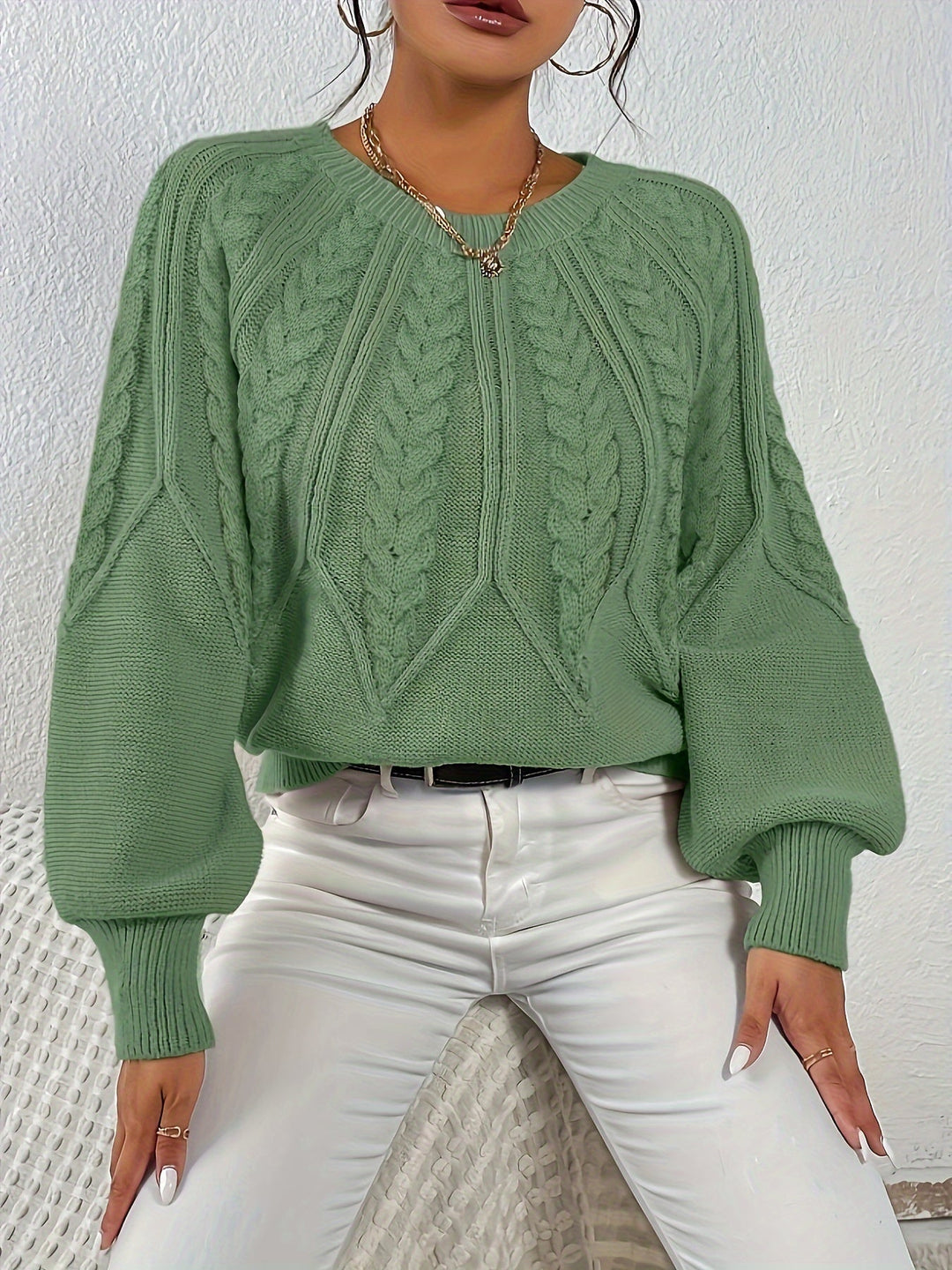 Chic women's cable knit pullover sweater, featuring a relaxed fit and elegant lantern sleeves.