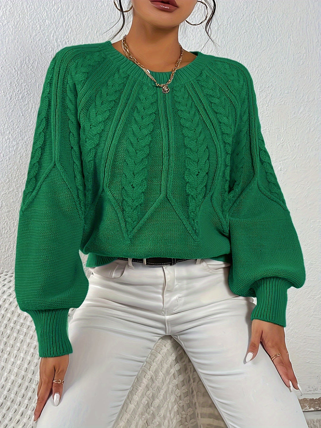 Cozy women's long sleeve sweater, relaxed fit, cable knit texture, and lantern sleeves.