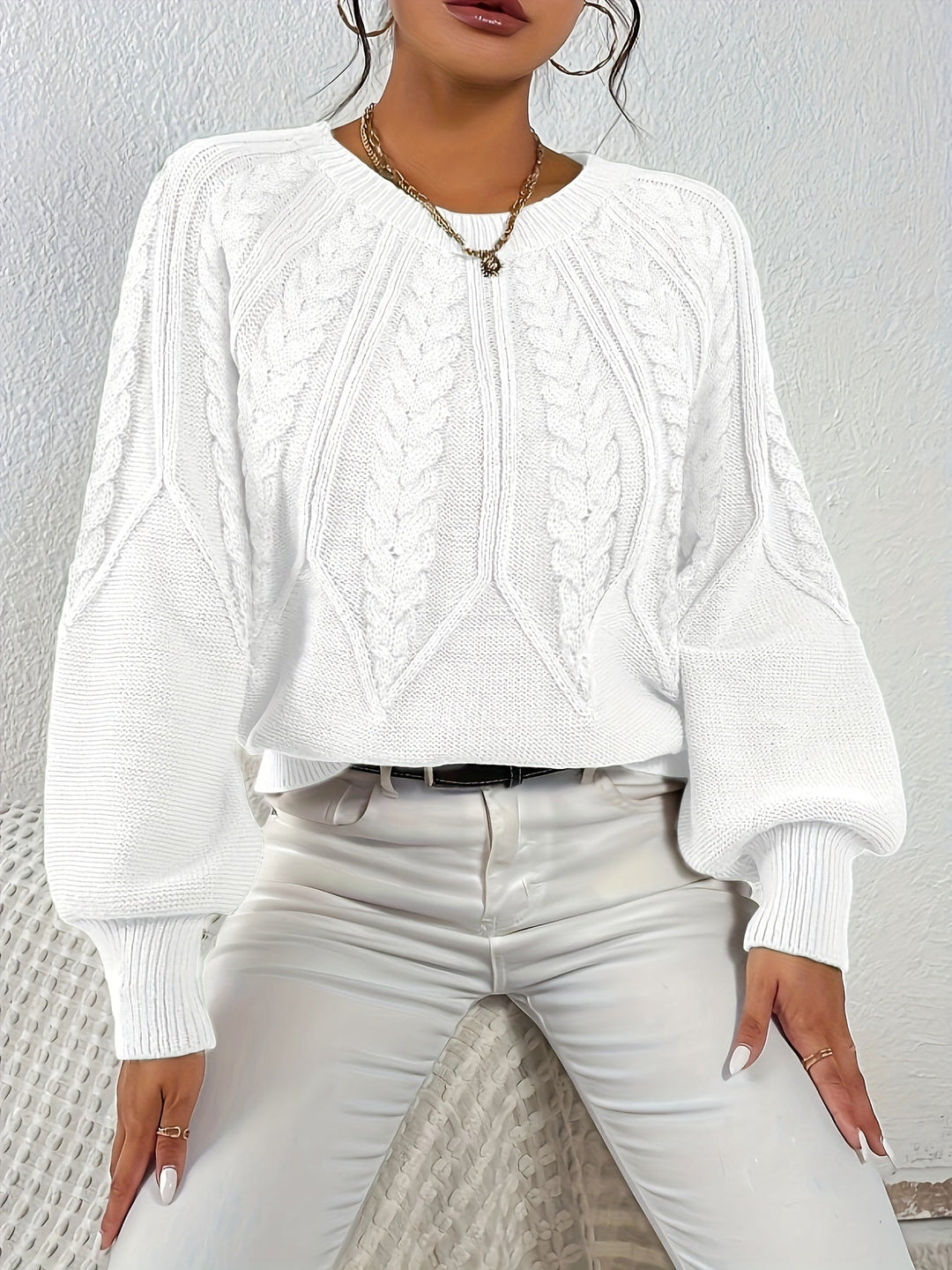 Women's relaxed fit cable knit pullover, perfect for fall layering, with lantern sleeves.
