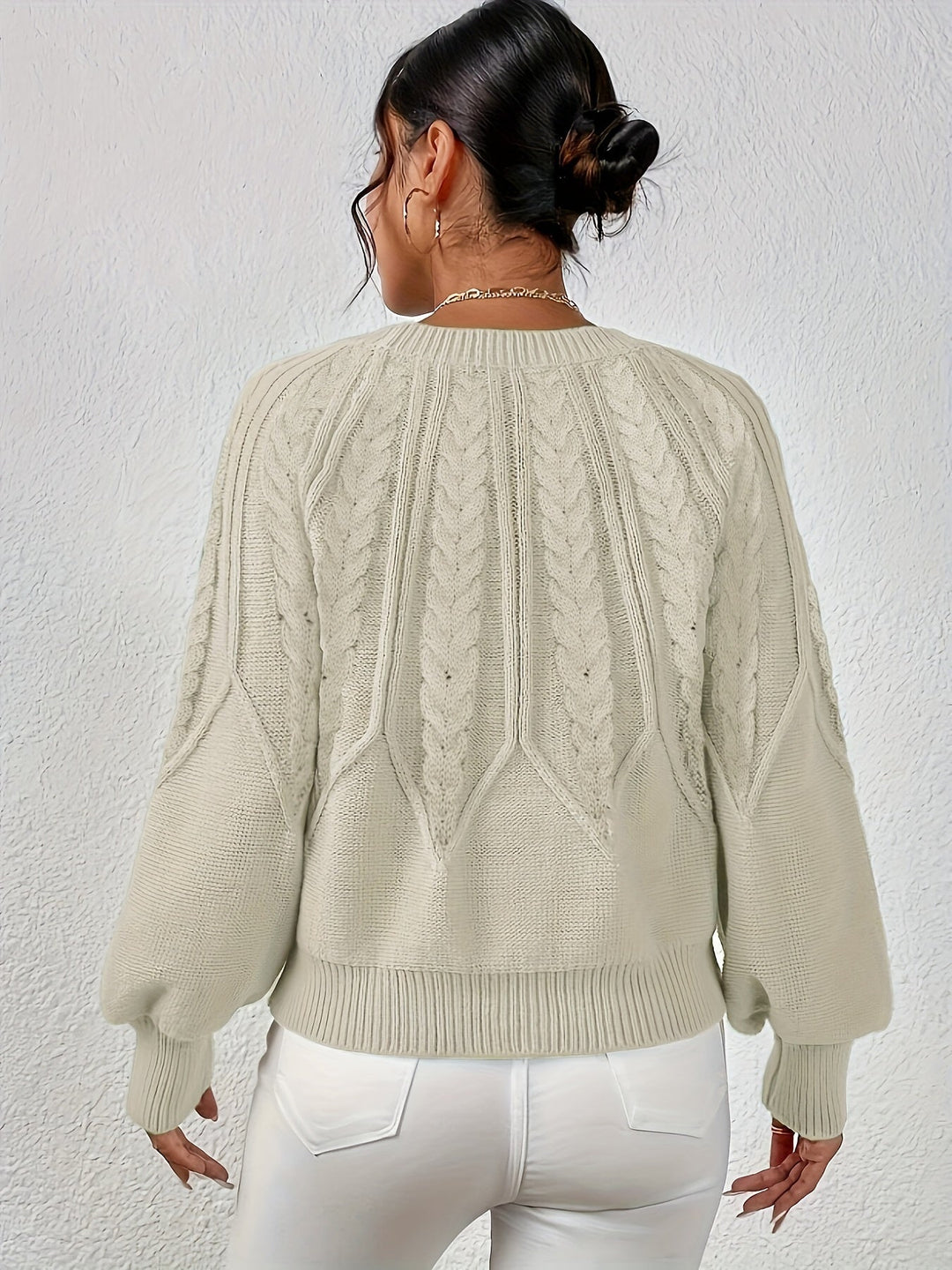 Winter warmth: Women's cozy cable knit sweater, relaxed fit, and stylish lantern sleeves.