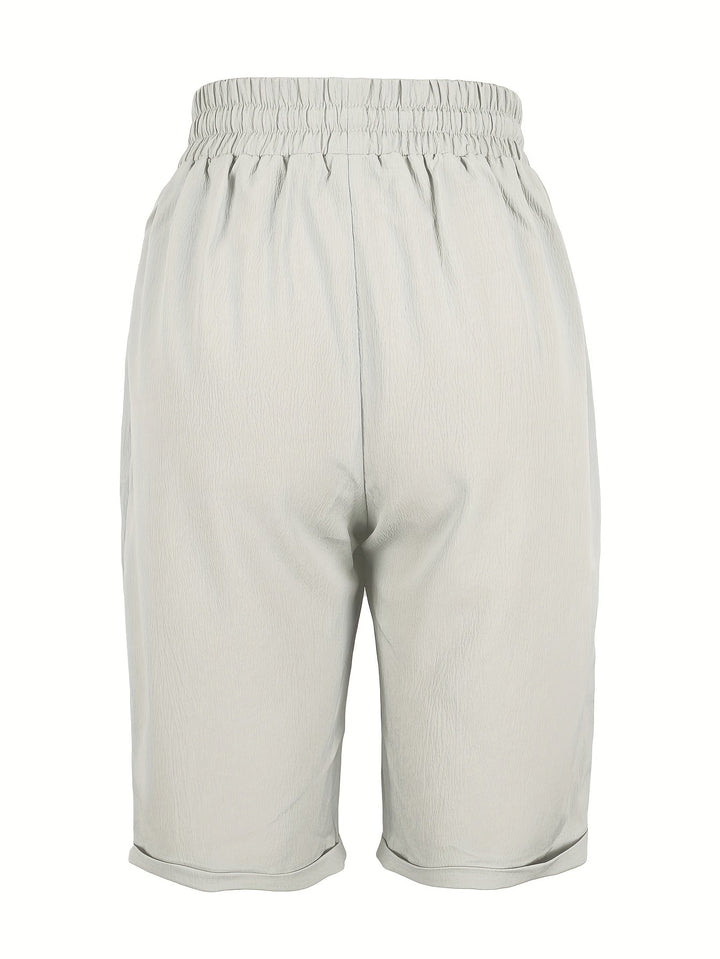 Relaxed fit women's mid-calf capri trousers with elastic waist, suitable for summer casual wear.