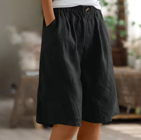 Chic women's mid-thigh shorts, offering a relaxed fit and practical elastic waist for daily comfort.