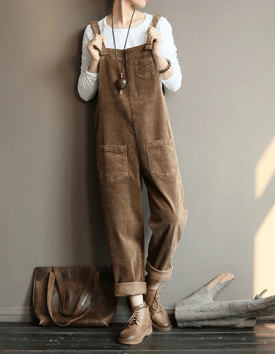 Women's relaxed fit corduroy dungaree jumpsuit with wide legs, perfect for vintage-inspired casual fall fashion.