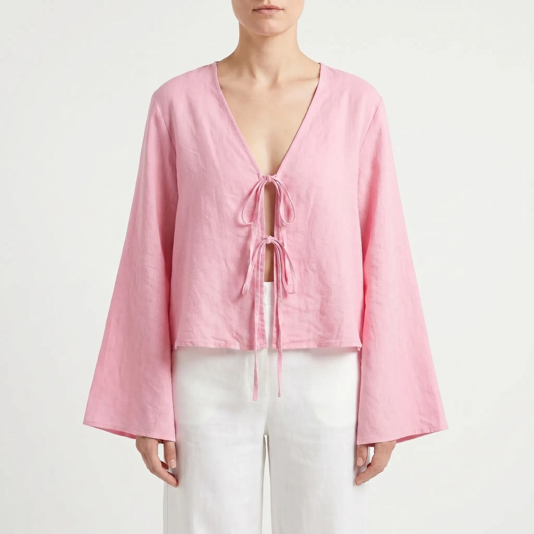 Soft pink relaxed fit women's blouse featuring a chic front-tie detail, great for warm weather.