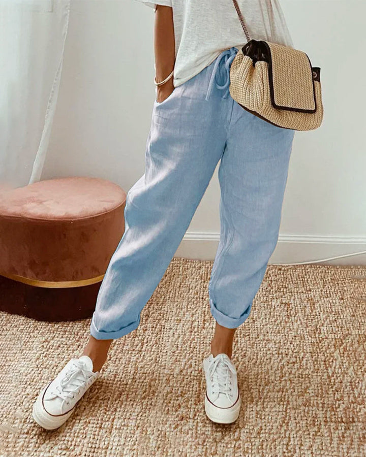 Woman wearing comfortable relaxed fit linen jogger pants with roll cuff, ideal for casual summer fashion.