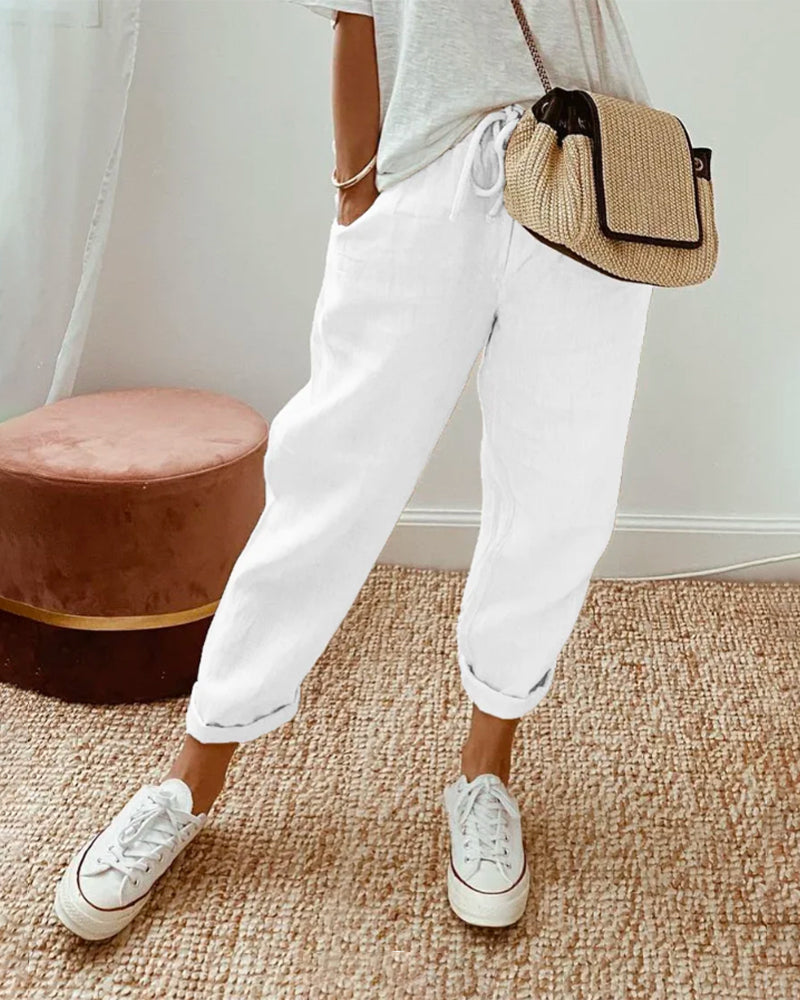Close-up of women's linen jogger pants, highlighting the adjustable drawstring waist and relaxed, flowy fit.
